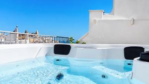 a jacuzzi tub with a view of the ocean at 21mq Suite Jacuzzi in Ostuni