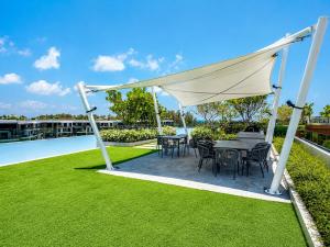 a tent on a lawn with tables and chairs at Sky Park Laguna 2BR Condo with Balcony in Laguna Phuket