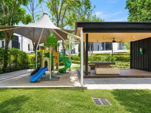 a playground with a slide and an umbrella at Sky Park Laguna 2BR Condo with Balcony in Laguna Phuket
