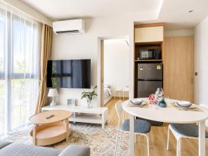 a living room with a white table and chairs at Sky Park Laguna 2BR Condo with Balcony in Laguna Phuket +24 photos