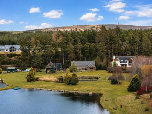 an aerial view of a house next to a lake at Lakeside Lodge, Views, Hot Tub & Fully Accessible in Elgin