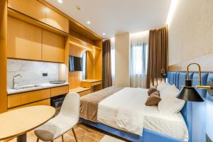 a hotel room with a bed and a table and chairs at Arbo Boutique Hotel in Durrës