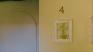 a door with a picture of a plant on the wall at Corte Pulchra - Italian Homing in Pozzolengo