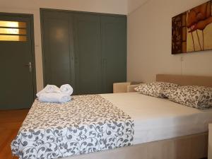 a bedroom with a bed with two towels on it at Errathens Apartments - Athens Center in Athens