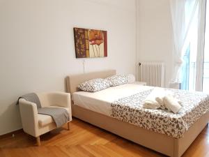 a bedroom with a bed and a chair at Errathens Apartments - Athens Center in Athens