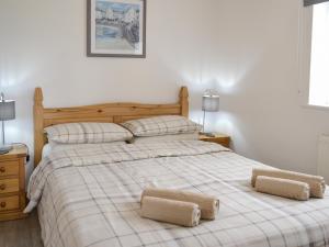 a bedroom with a bed with two pillows on it at Sunset in St Austell