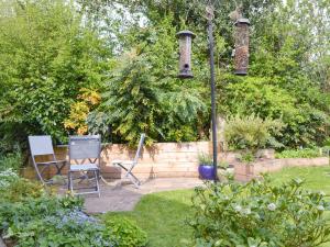 a garden with two chairs and a light pole at Keldholme Cottage 1 - Uk10992 in Kirkbymoorside