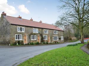 a brick house with a red roof on a street at Keldholme Cottage 1 - Uk10992 in Kirkbymoorside