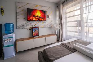 a bedroom with a bed and a fire on the wall at Studio Apartment with balcony in Ngara in Nairobi