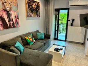 a living room with a couch and a table at Annaria in Leptokarya
