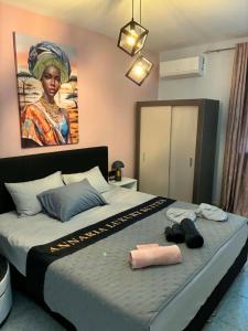 a bedroom with a large bed with a painting on the wall at Annaria in Leptokarya