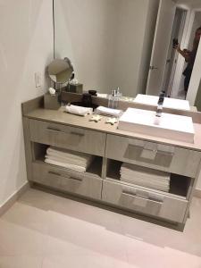 a bathroom with a sink and a mirror at LYFE 4111 S Ocean dr in Hollywood