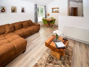 a living room with a couch and a table at Bluebird Lodge 2 - Uk50932 in High Nibthwaite