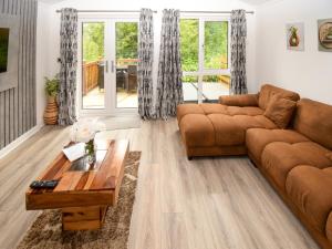 a living room with a couch and a coffee table at Bluebird Lodge 2 - Uk50932 in High Nibthwaite +9 photos