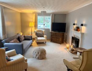 a living room with a couch and a tv at No 1 The Martins in Southwold