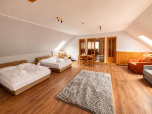a bedroom with two beds and a living room at Spring Apartments in Gheorgheni