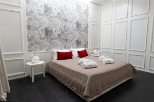 a bedroom with a large bed with red pillows at Villa Ascosa - Relais sul Mare in Trani +99 photos