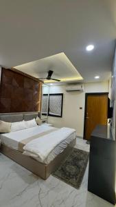 a bedroom with a large bed in a room at Hotel Gatik Inn in Sānāwad