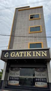 a tall building with a sign that reads gatink inn at Hotel Gatik Inn in Sānāwad +22 photos