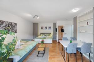 a living room with a couch and a bed at Schanzenblick mit Sauna und Pool in Schönwald