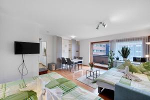 a living room with two beds and a living room at Schanzenblick mit Sauna und Pool in Schönwald