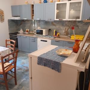 a kitchen with blue cabinets and a counter top at Apartment ANDRIUCI in Cavtat +52 photos