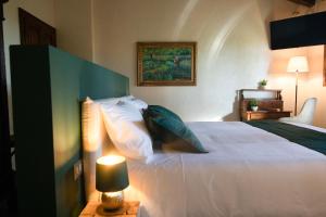 a bedroom with a large white bed with pillows at VM Boutique in Castiglione di Ravenna