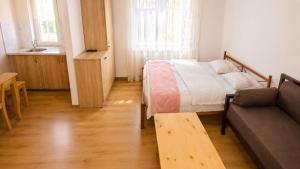 a small bedroom with a bed and a couch at Tuz House R2 in Bakuriani