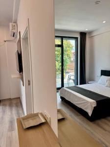 a bedroom with a bed and a tv and a window at Mimar Boutique in Eforie Sud