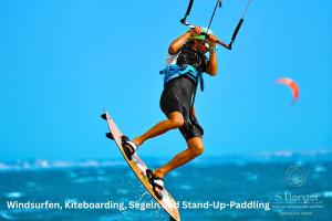 a man is in the air on a board at Haus Schultz "Traumblick 3" in Hedehusum