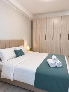 a bedroom with a large bed with towels on it at Saltanat hotel in Alghabas