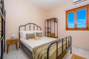 a bedroom with a bed in a room with a window at Rocabella Home in Kriopigi