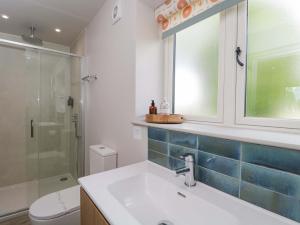 a bathroom with a sink and a glass shower at Poppy Patch in Bicester +11 photos