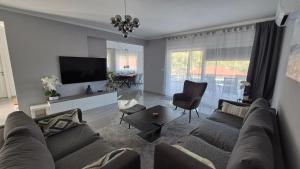a living room with a couch and a flat screen tv at Villa Aylen in Mošćenička Draga