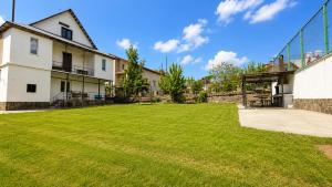 a large yard in front of a building at Tuz House R2 in Bakuriani +8 photos
