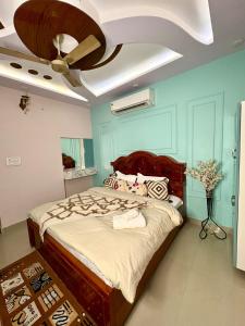 a bedroom with a bed with a ceiling fan at Riddhihomestay in Jaipur