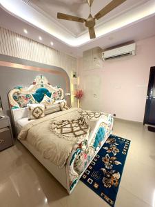 a bedroom with a large bed with an elaborate headboard at Riddhihomestay in Jaipur