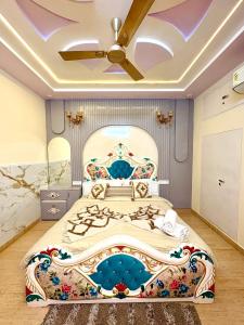 a bedroom with a large bed with a painting on it at Riddhihomestay in Jaipur