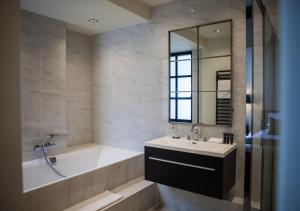 a bathroom with a tub and a sink and a bath tubermott at B in Antwerp in Antwerp +73 photos