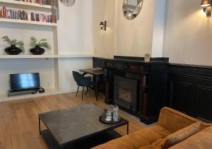 a living room with a couch and a fireplace at B in Antwerp in Antwerp