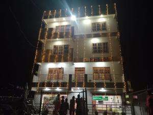 a tall building with people standing in front of it at Hotel Himalayan Inn, khona in Pātan
