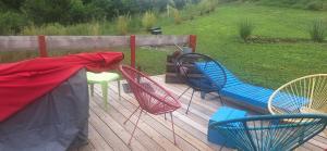 a group of chairs sitting on a deck at Bambolina in Marche-en-Famenne +6 photos