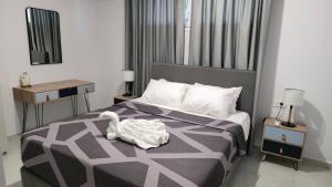 a bedroom with a bed with a swan on it at Kos Cozy Home in Platánion