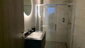 a bathroom with a sink and a shower at Kos Cozy Home in Platánion +109 photos