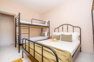 a bedroom with two bunk beds in a room at Rocabella Home in Kriopigi