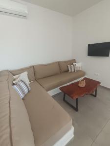 a living room with a couch and a coffee table at IOVI Tinos II in Agios Sostis