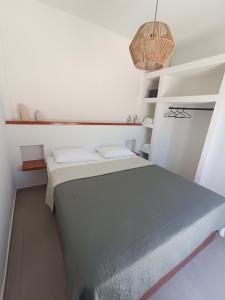 a small room with a bed and a table at IOVI Tinos II in Agios Sostis