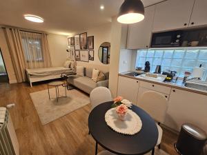 a kitchen and a living room with a table and chairs at Vukajlo Petit in Belgrade