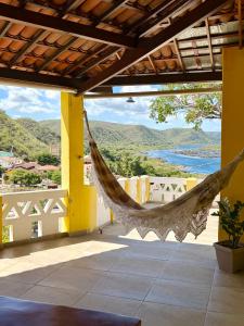 a hammock hanging from a building with a view at Casa Bela Vista in Piranhas