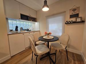 a kitchen and dining room with a table and chairs at Vukajlo Petit in Belgrade